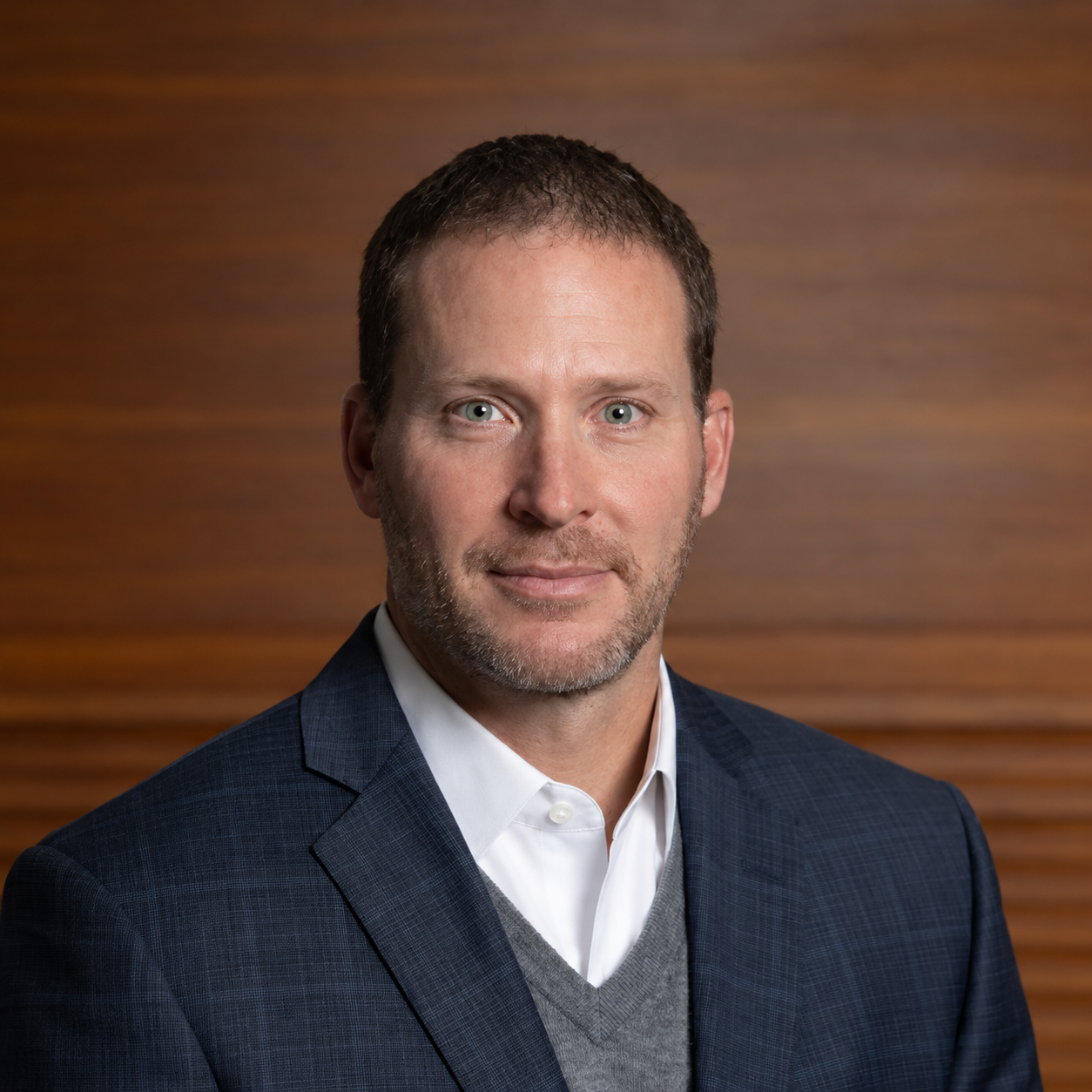 Professional Corporate Headshot on Warm Wood
